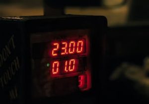 Close-up of an illuminated taxi meter showing fares and distance in Mumbai, India. Captured at night.