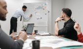 Colleagues in a business meeting discussing data and strategies at the office.